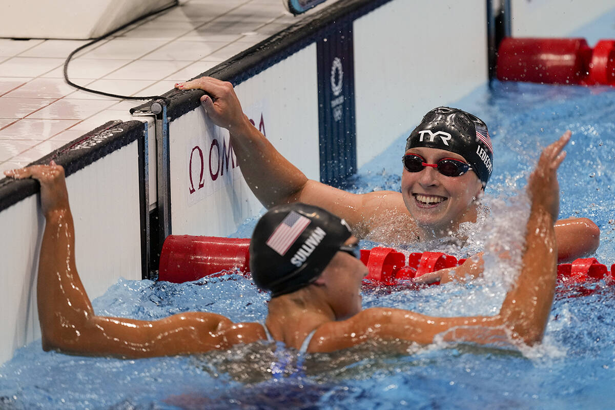 Katie Ledecky, right, of the United States, celebrates after winning the women's 1500-meters fr ...