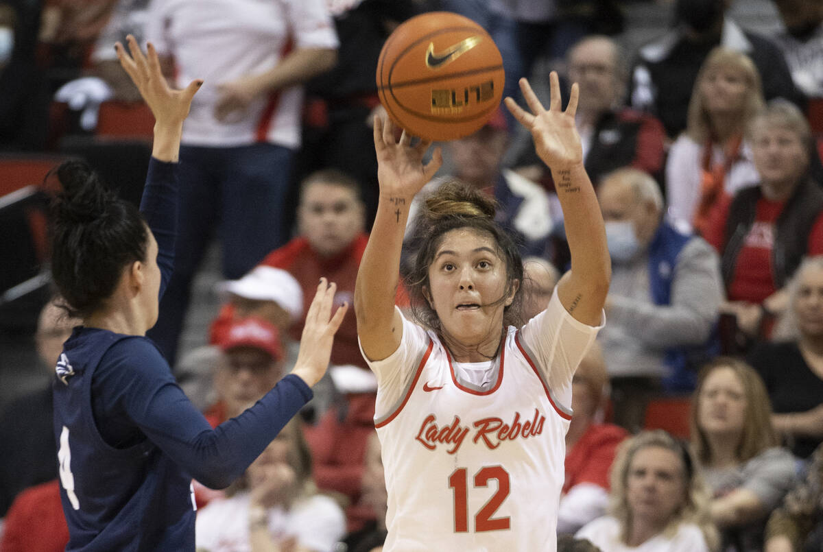 UNLV Lady Rebels guard Alyssa Durazo-Frescas (12) shoots over Nevada Wolf Pack guard Audrey Rod ...