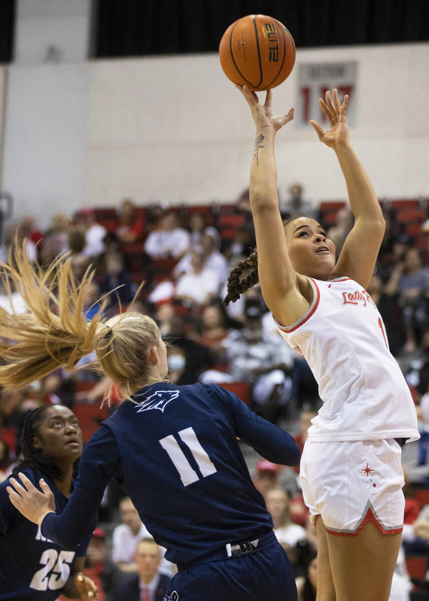 UNLV Lady Rebels forward Nneka Obiazor (1) shoots over Nevada Wolf Pack guard Kenna Holt (11) i ...