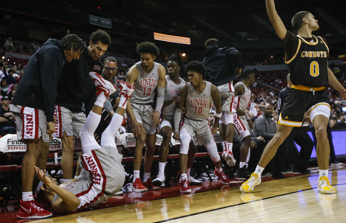 Teammates of UNLV Rebels guard Justin Webster, lower left, celebrate after he scored against th ...