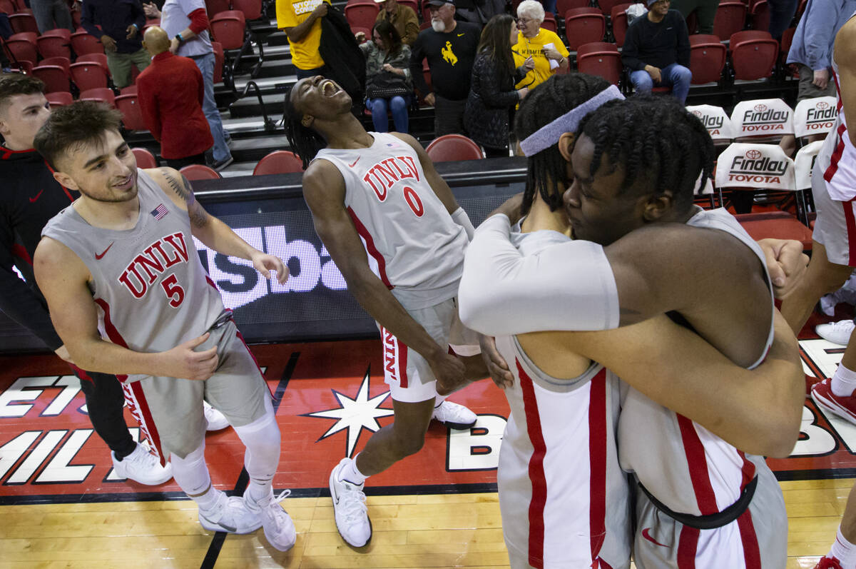 UNLV Rebels forward Victor Iwuakor (0) celebrates alongside UNLV Rebels guard Jordan McCabe (5) ...