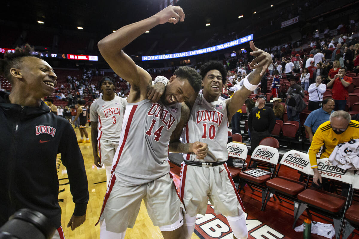 UNLV Rebels forward Royce Hamm Jr. (14) and guard Keshon Gilbert (10) celebrate after defeating ...