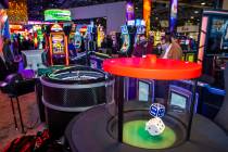 Dice hop during a roll in the new stadium seating and gaming spot about the Scientific Games Co ...