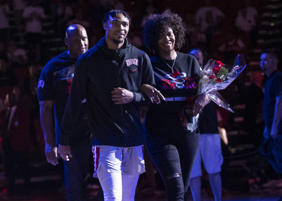 UNLV Rebels guard Bryce Hamilton (13) walks with his mother, Jamie Jackson, and father, Kevin H ...