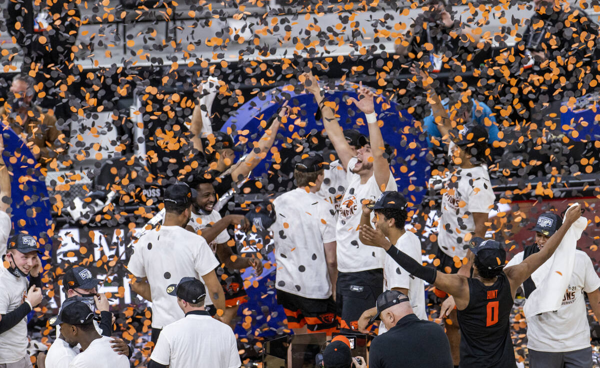 Oregon State Beavers players celebrate their win with confetti after defeating the Colorado Buf ...