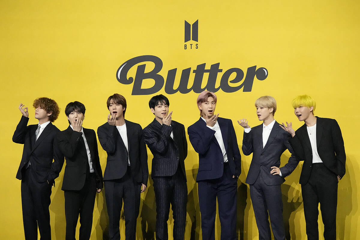 Members of South Korean K-pop band BTS pose for photographers ahead of a press conference to in ...