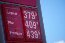 FILE - In this Oct. 24 2021, file photo, gas pump prices are posted on a sign at a Conoco stati ...