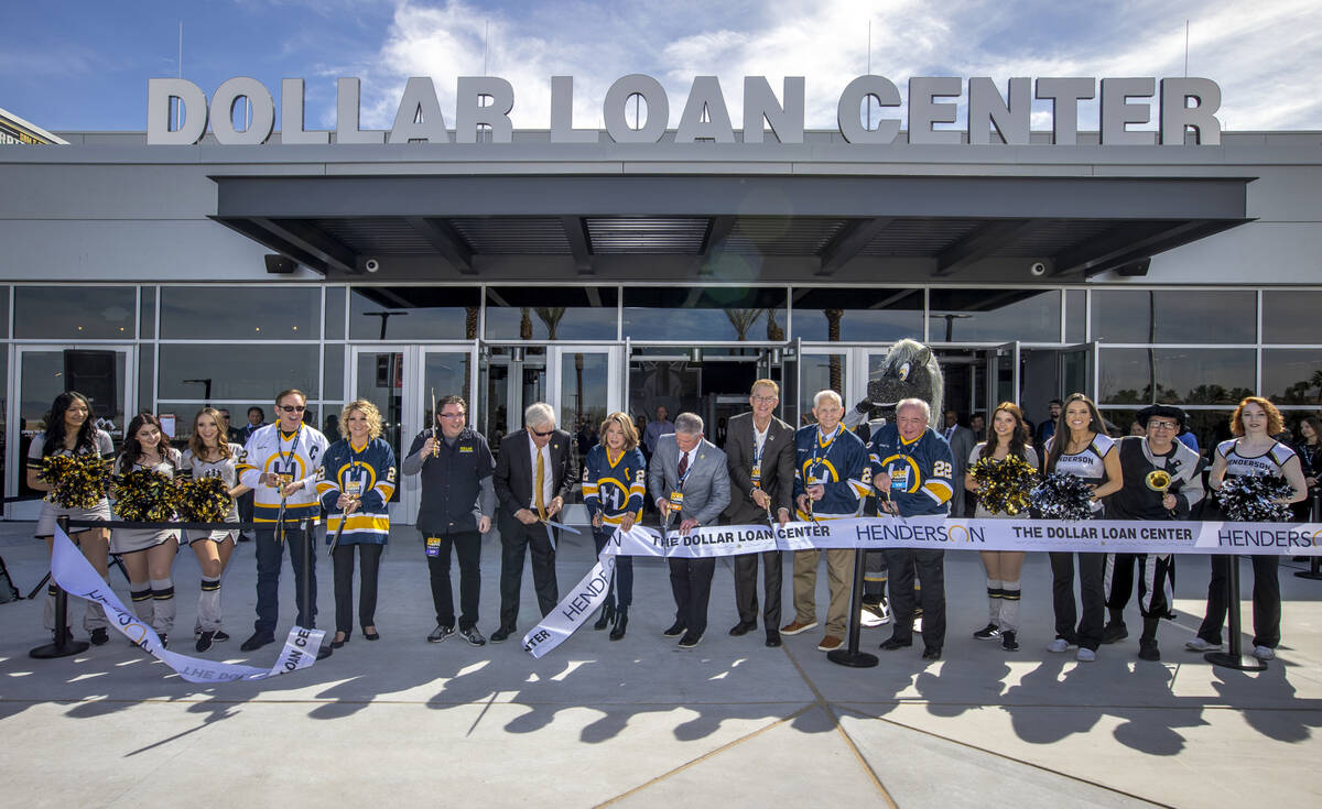 Dignitaries cut a ribbon beside arena staff during a ceremony for the new Dollar Loan Center on ...