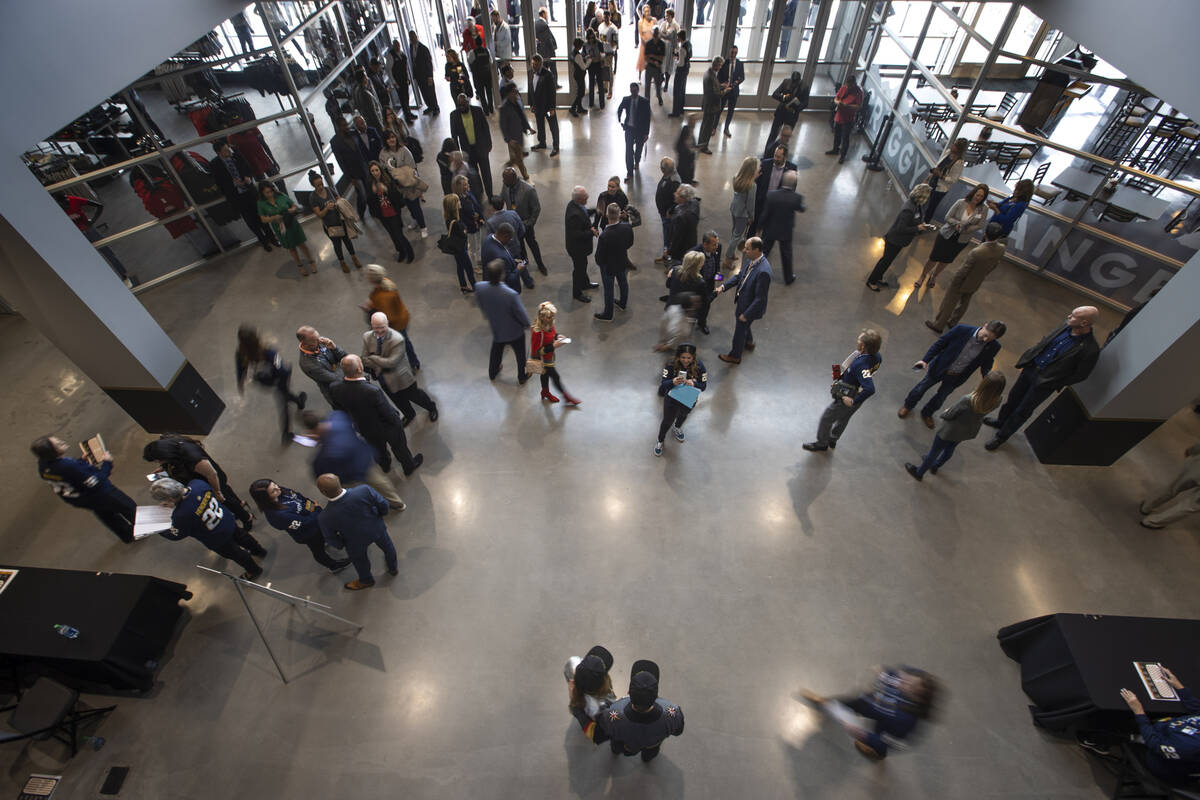 Attendees begin to flow through the entrance of the arena following a ribbon-cutting ceremony f ...