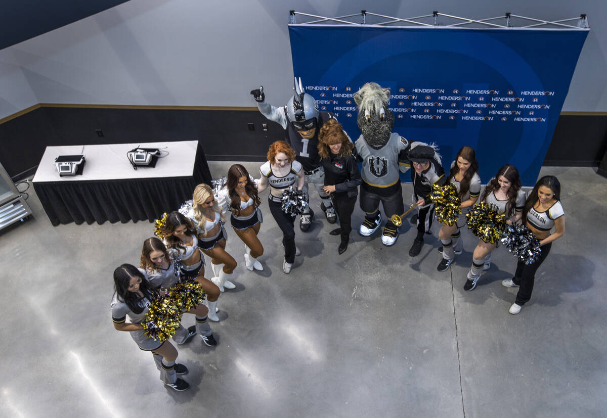 Staff and mascots gather for photos inside the arena following a ribbon-cutting ceremony for th ...