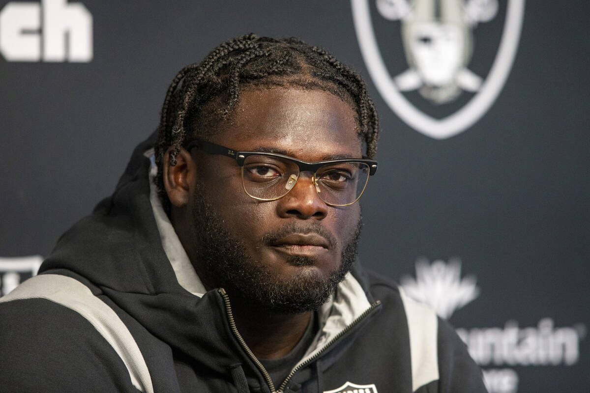 Raiders offensive tackle Alex Leatherwood listens to questions during a news conference at the ...