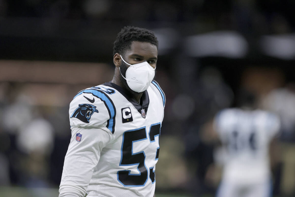 FILE – Carolina Panthers defensive end Brian Burns (53) wears a mask as he  warms up before an N …
