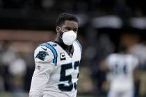 Carolina Panthers defensive end Brian Burns (53) wears a mask as he warms up before an NFL foot ...