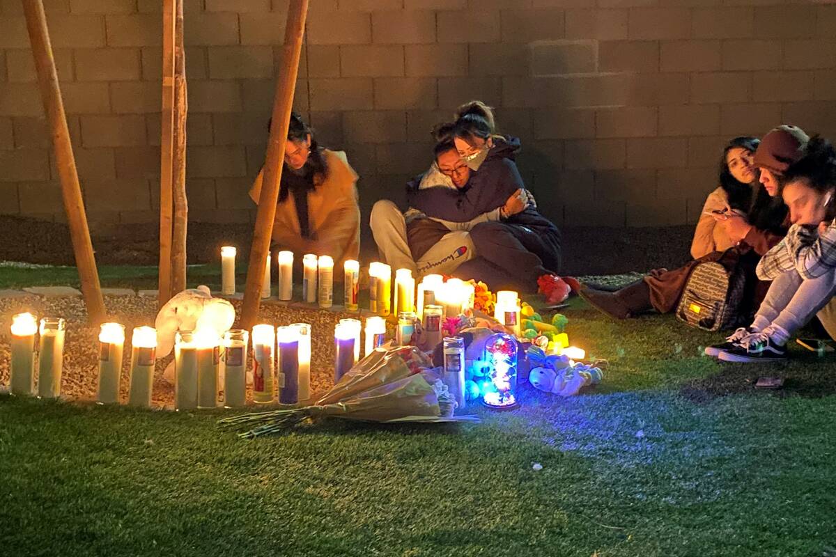 People gather around a memorial for Mason Dominguez, 4, on Wednesday, Feb. 23, 2022, outside th ...