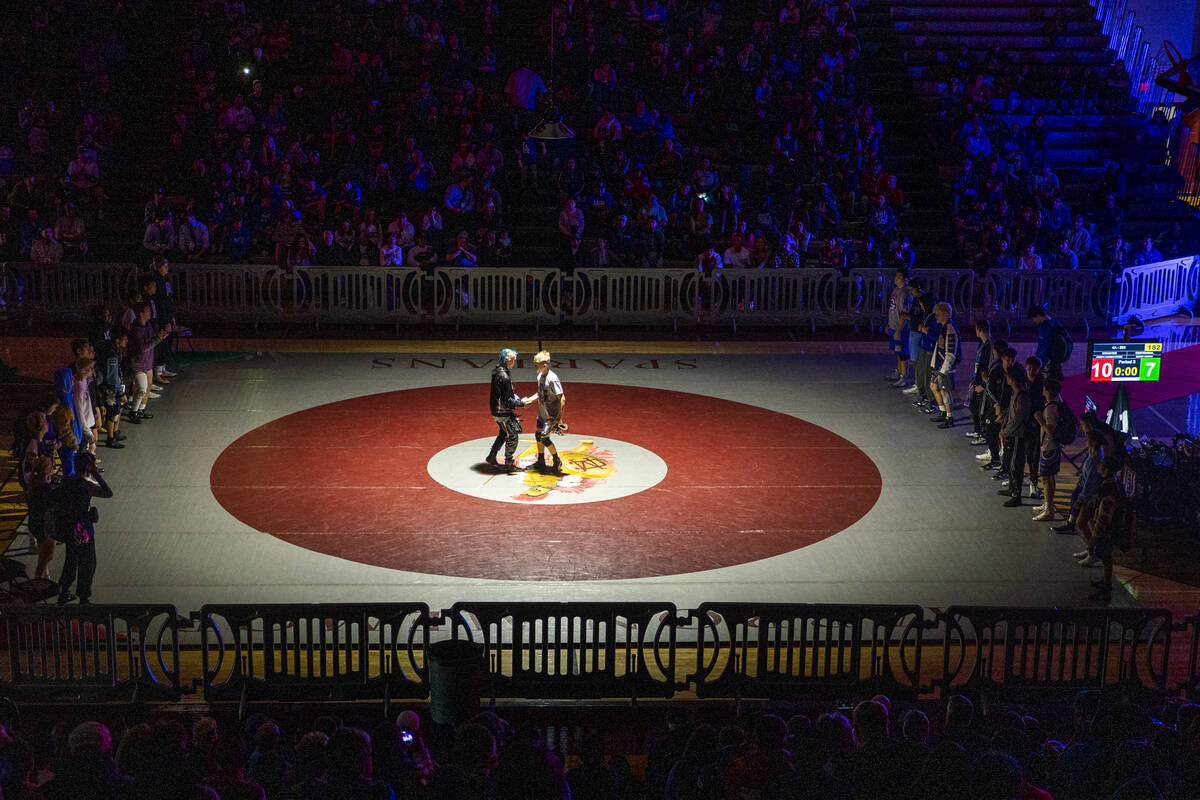 Competitors meet in the center of the mat after being introduced during the 4A state wrestling ...
