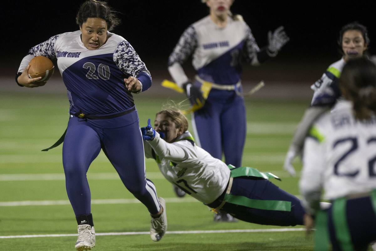Shadow Ridge’s Mikayla Brown (20) scrambles out of the grasp of Enjoli DePhillipo (17) ...
