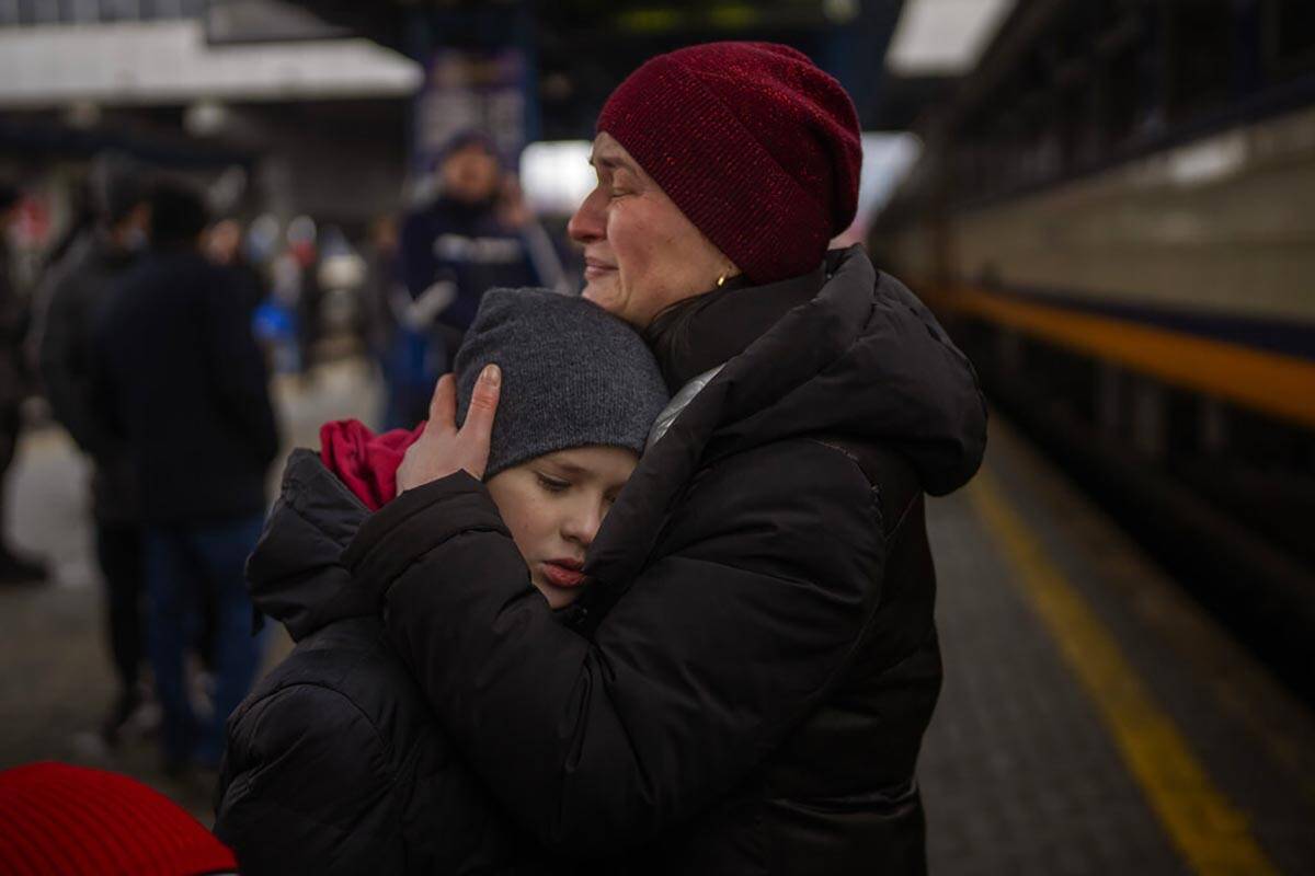 Tanya, 38, cries with her son Bogdan, 10, before getting a train to Lviv at the Kyiv station, U ...