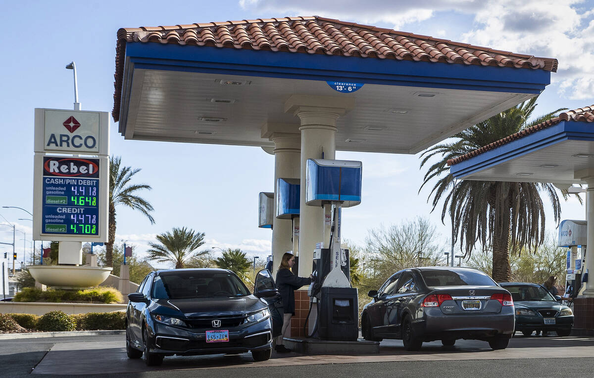 Customers pump gas at the Arco/Rebel store along North Buffalo Drive on Friday, March 4, 2022, ...