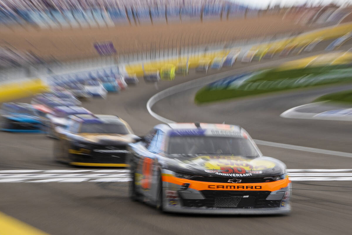 Racers round the corner during the NASCAR Xfinity Series Alsco Uniforms 300 on Saturday, March ...