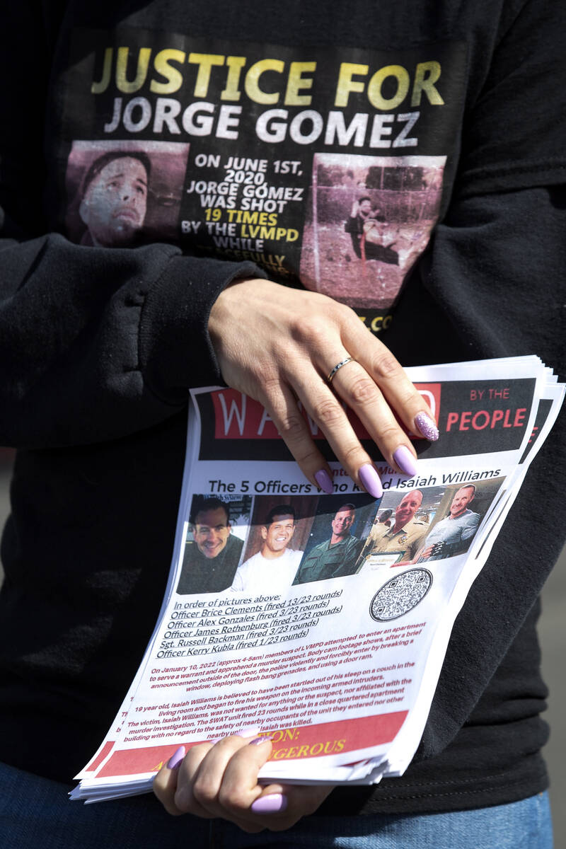 An attendee hands out flyers during a press conference held by the family of Isaiah Williams at ...