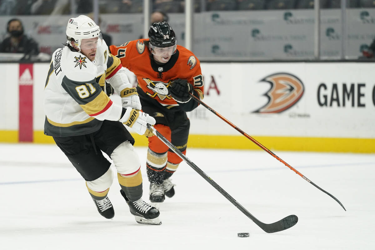 Golden Knights and Anaheim Ducks players battle to an empty arena during  the first period of an …