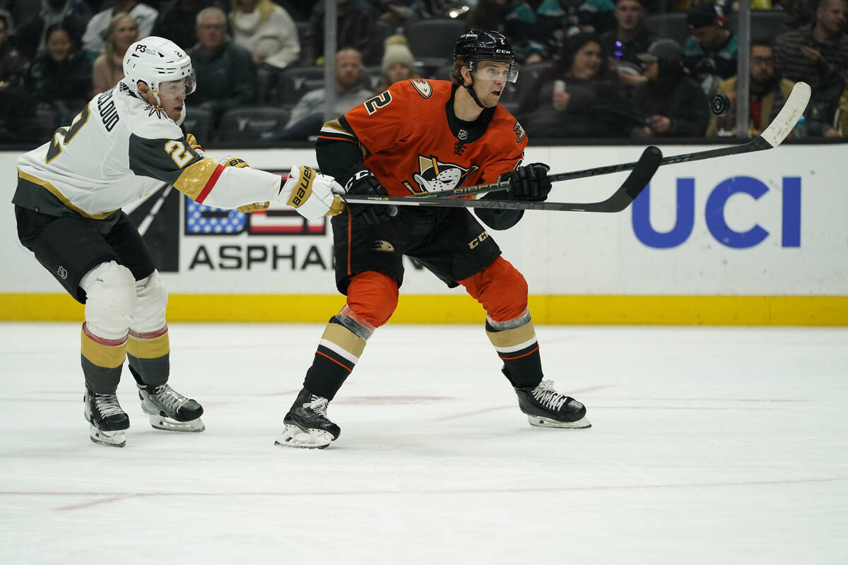 Vegas Golden Knights defenseman Zach Whitecloud, left, defends against Anaheim Ducks defenseman ...