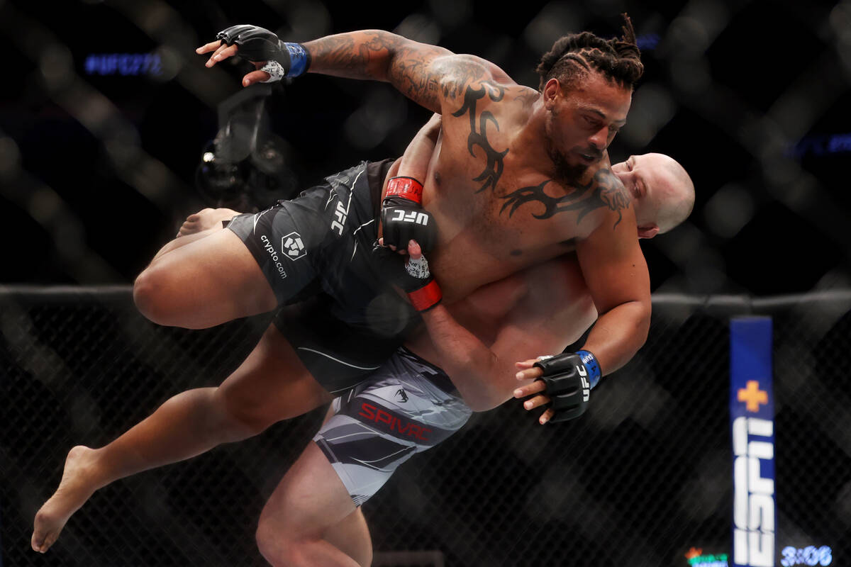 Serghei Spivac, rear, takes down Greg Hardy in the first round of the UFC 272 heavyweight bout ...
