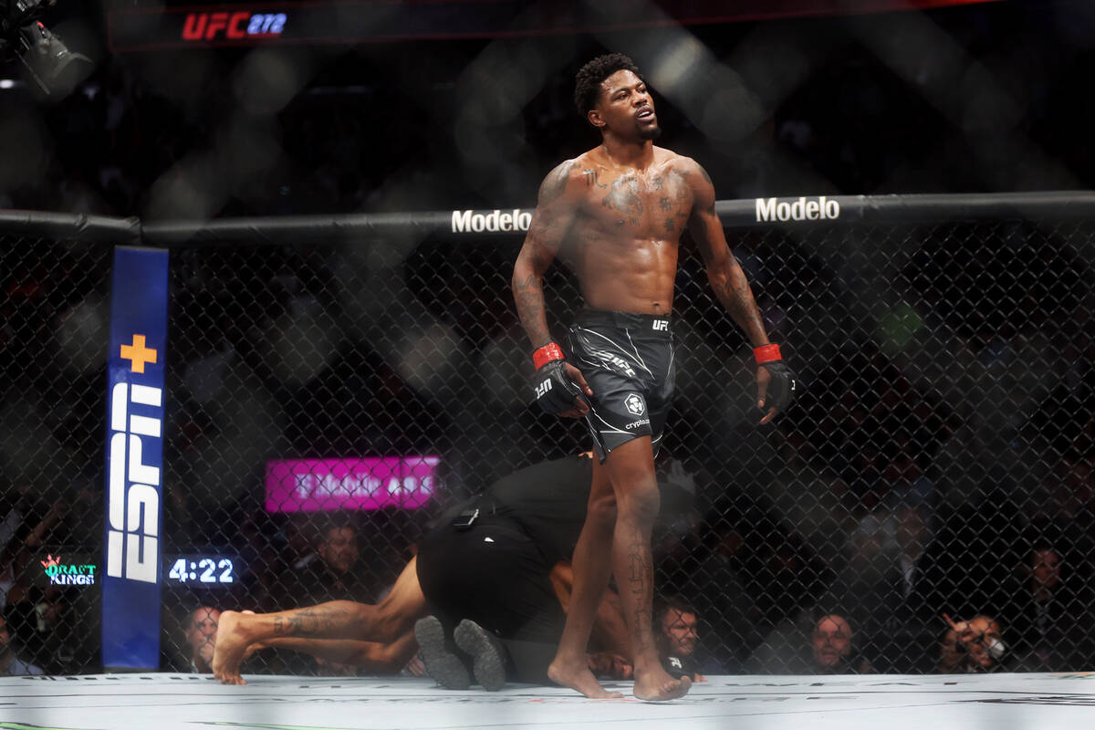 Kevin Holland, left, finishes Alex Oliveira in the second round during an UFC 272 welterweight ...