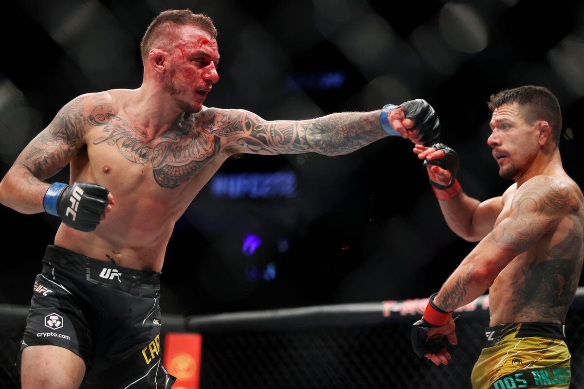 Renato Moicano, left, battles Rafael Dos Anjos in the fifth round of an UFC 272 catchweight bou ...
