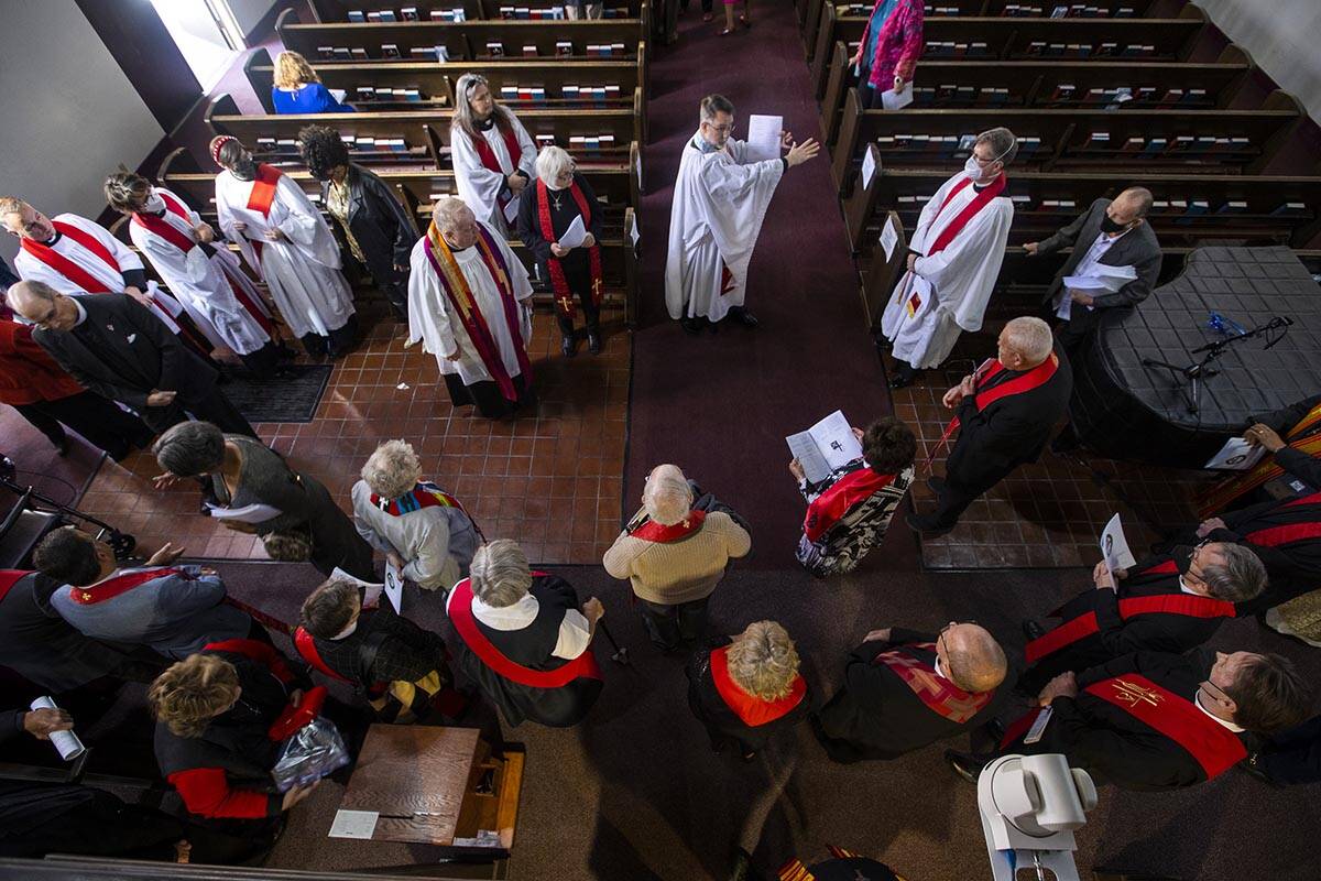 Priests and other religious figures go over last minute instructions before the Rev. Elizabeth ...