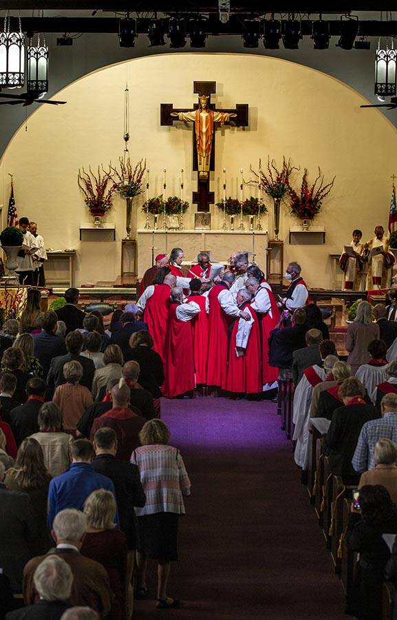 The Rev. Elizabeth Bonforte Gardner, center, has hands laid on her while presiding Bishop Micha ...