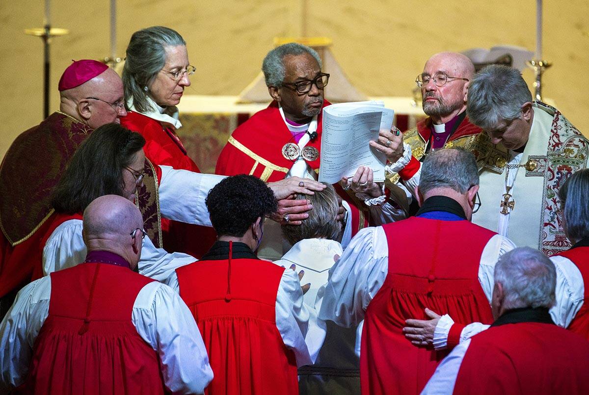 The Rev. Elizabeth Bonforte Gardner, center, has hands laid on her while presiding Bishop Micha ...