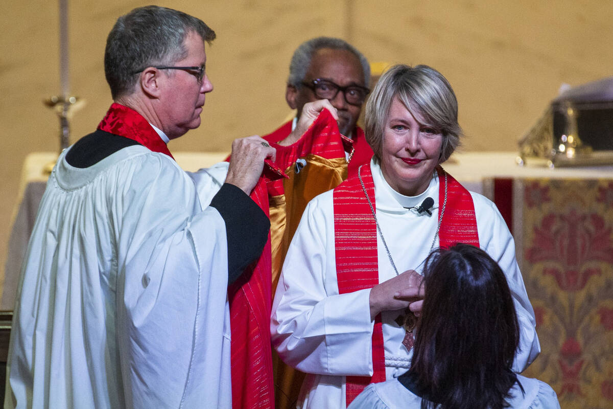 Bishop Elizabeth Bonforte Gardner receives her Bishop’s robes while consecrated the next ...