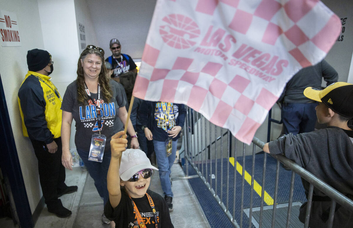 Katelynn Marino, from San Diego, Calif., waves her racing flag during the Pennzoil 400 NASCAR C ...