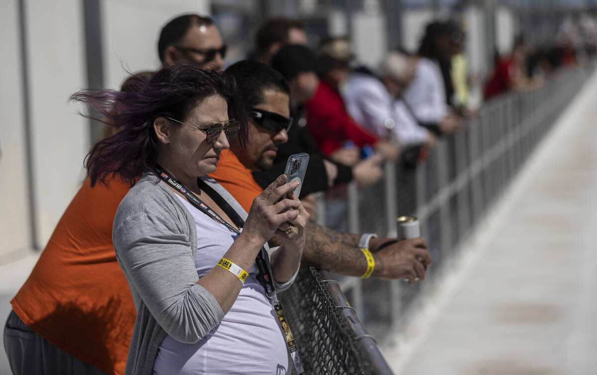 Fans watch the start of the Pennzoil 400 NASCAR Cup Series race on Sunday, March 6, 2022, at La ...