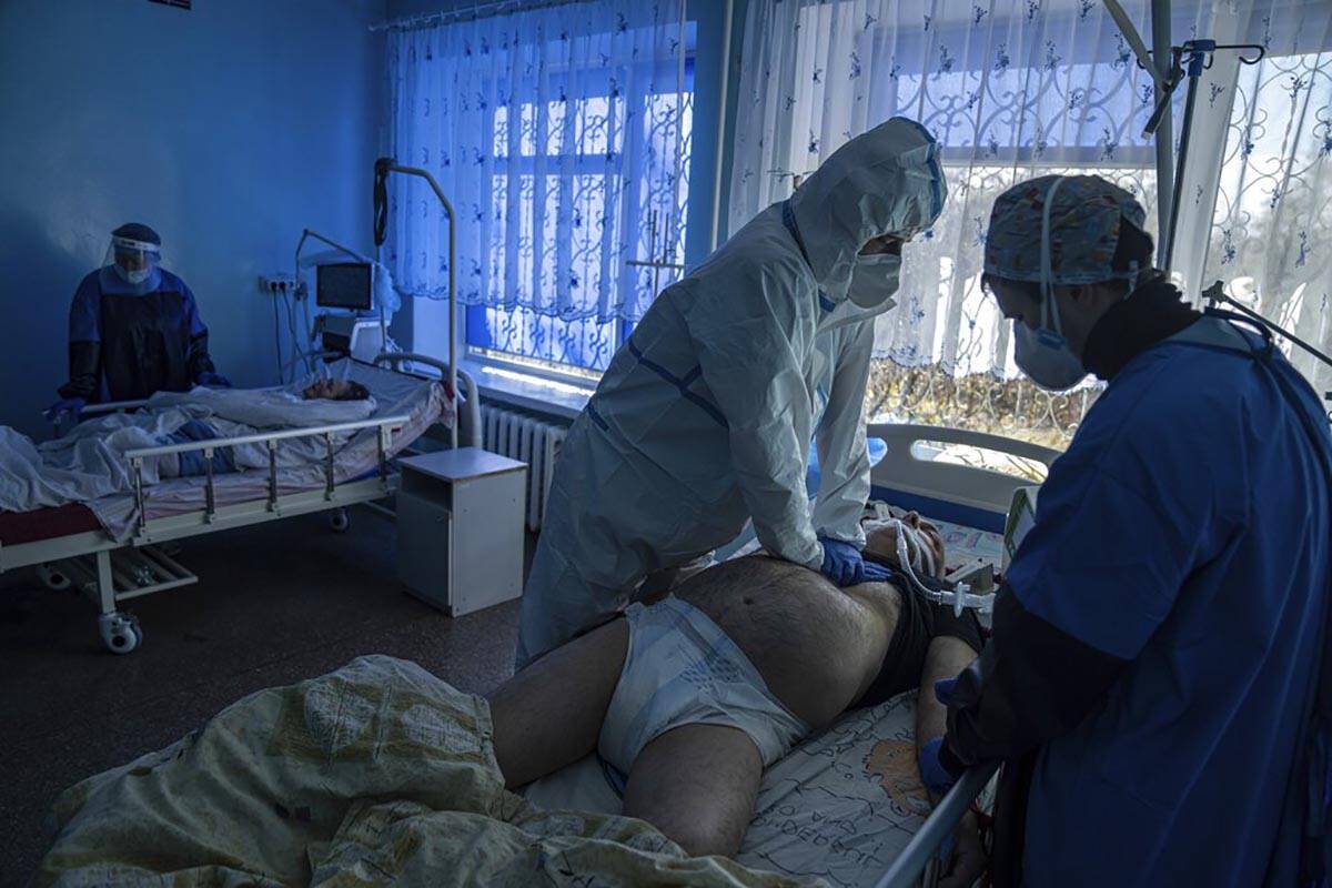 FILE - Dr. Oleksandr Molchanov, second right, and another medical worker perform CPR on a patie ...