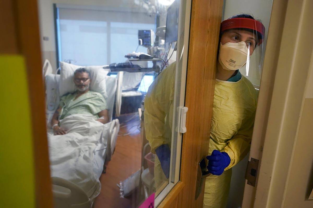 FILE - Registered nurse Rachel Chamberlin steps out of an isolation room where Fred Rutherford ...