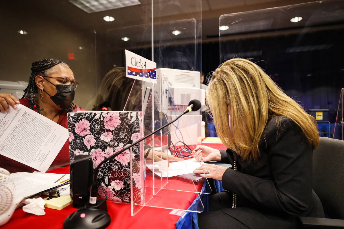 Venicia Considine, right, is helped by Essie Henson, office assistant for the Clark County elec ...