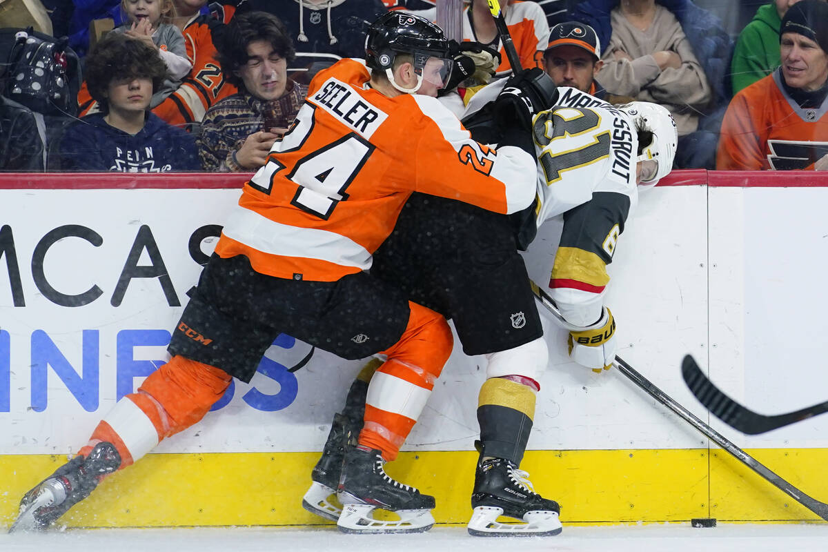 Philadelphia Flyers' Nick Seeler, left, and Vegas Golden Knights' Jonathan Marchessault collide ...
