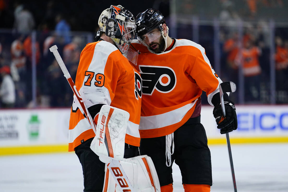 Philadelphia Flyers' Carter Hart, left, and Keith Yandle celebrate after an NHL hockey game aga ...