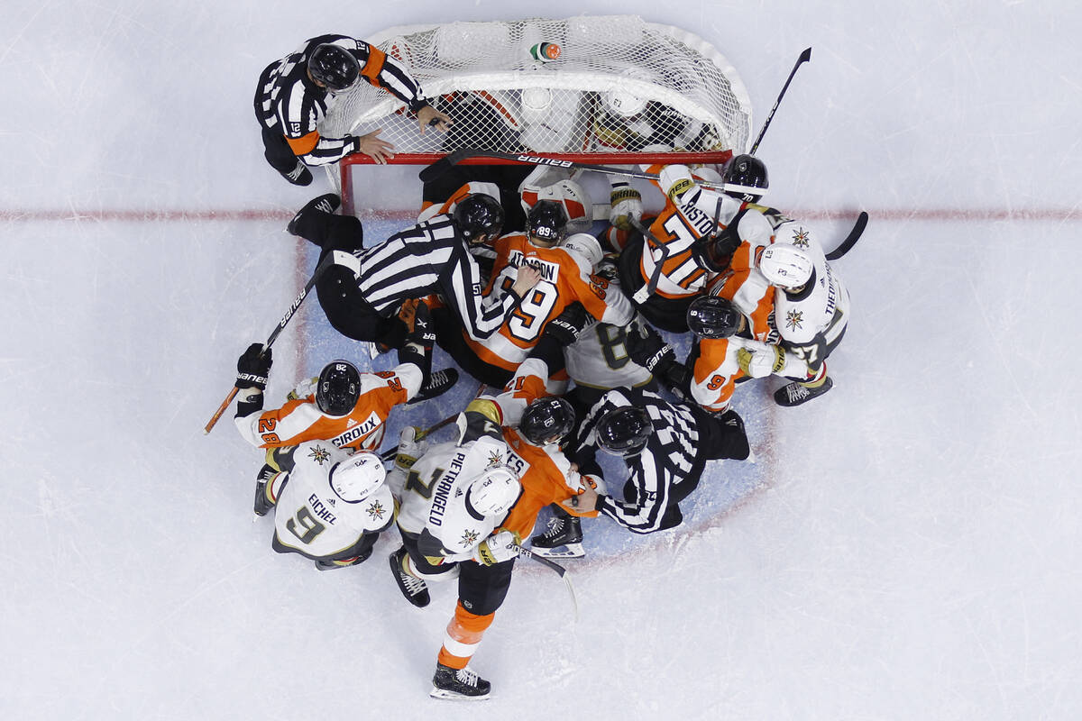 Philadelphia Flyers players and Vegas Golden Knights players wrestle during the first period of ...