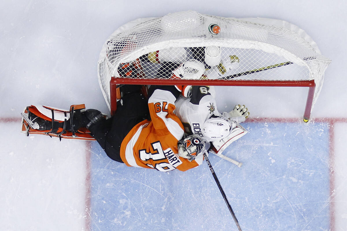 Vegas Golden Knights' Jack Eichel, right, collides with Philadelphia Flyers' Carter Hart during ...