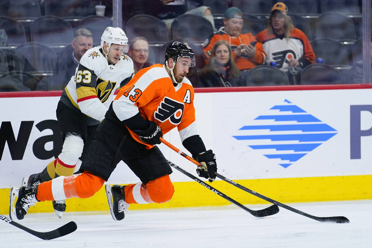 Philadelphia Flyers' Kevin Hayes, right, and Vegas Golden Knights' Evgenii Dadonov battle for t ...