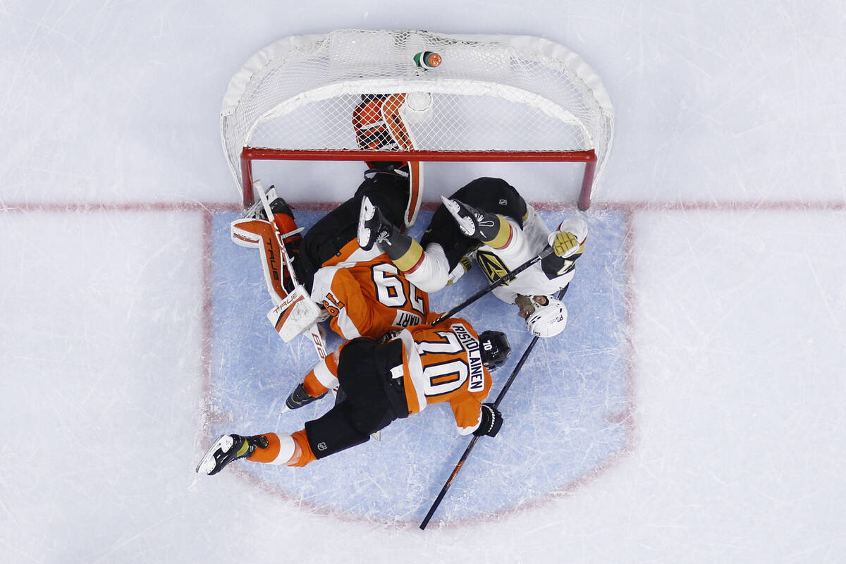Vegas Golden Knights' Max Pacioretty, right, collides with Philadelphia Flyers' Carter Hart, le ...