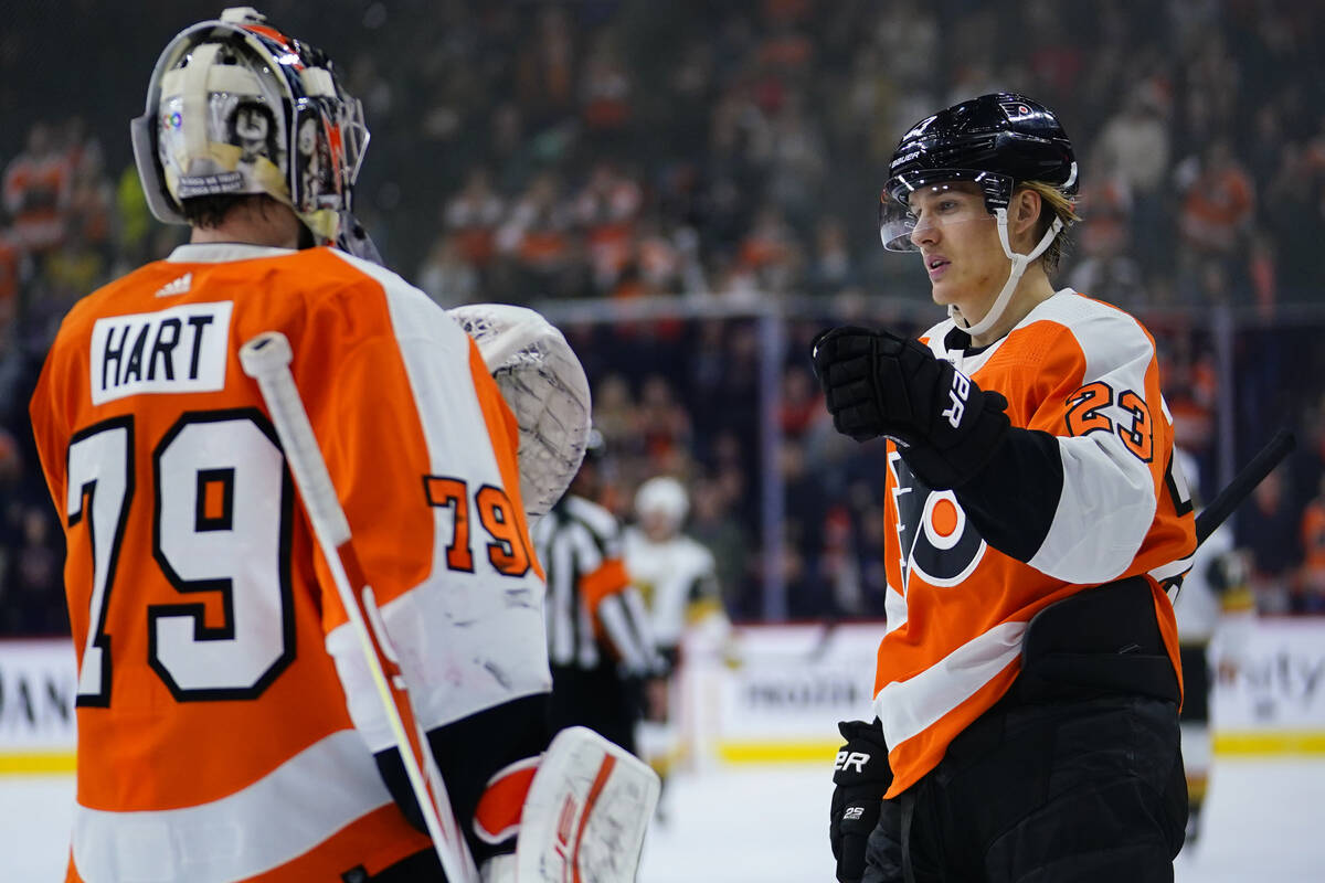 Philadelphia Flyers' Oskar Lindblom, right, and Carter Hart celebrate after a goal during the f ...