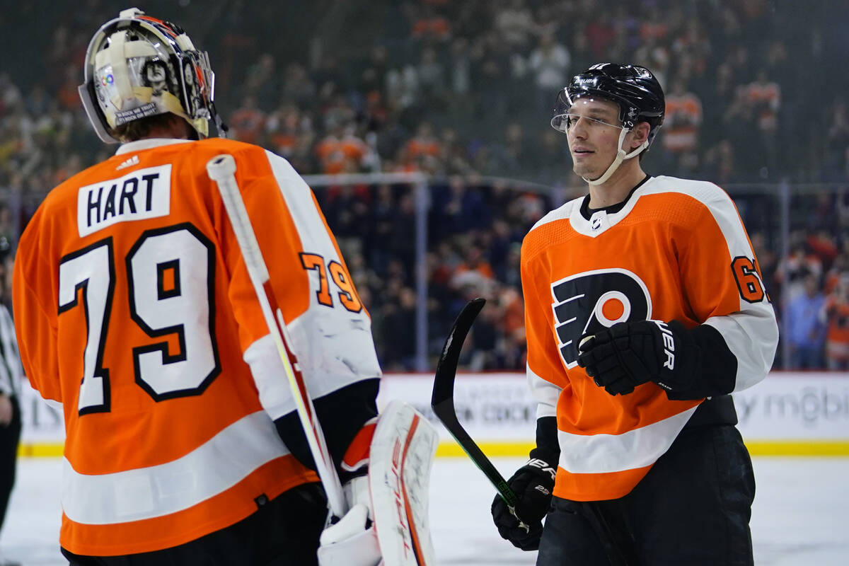 Philadelphia Flyers' Justin Braun, right, and Carter Hart celebrate after a goal during the fir ...