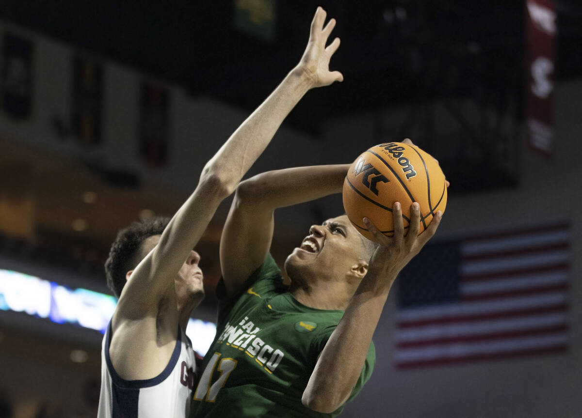 San Francisco Dons forward Patrick Tape (11) is fouled on the way to the rim by Gonzaga Bulldog ...
