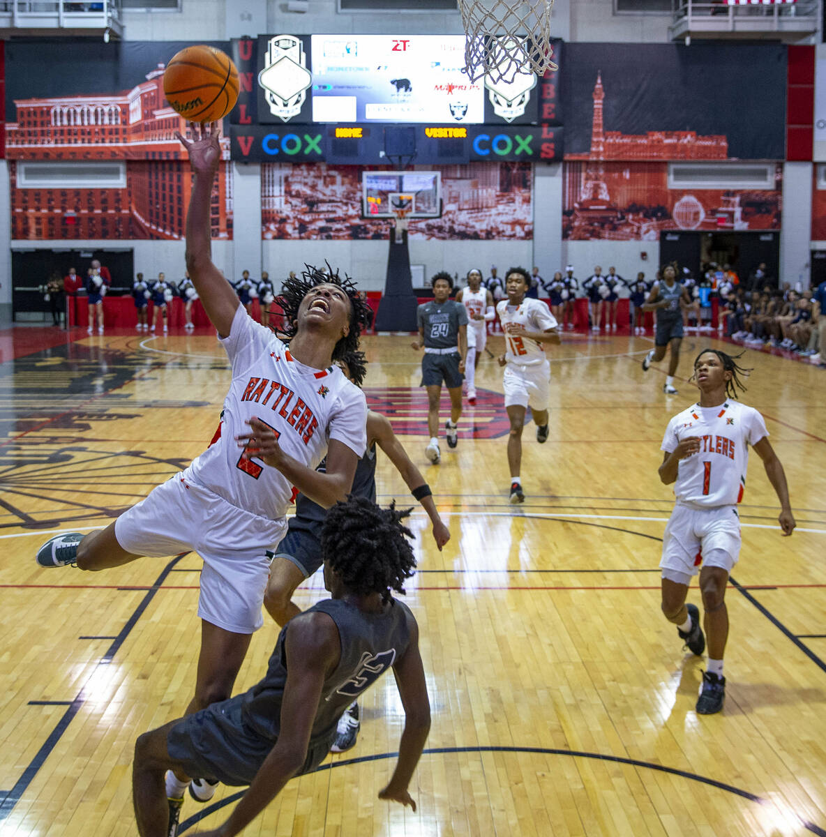 Mojave guard Giali Chapman (2) extends for a shot over Spring Valley’s guard Jordon Cosb ...