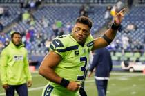 Seattle Seahawks quarterback Russell Wilson waves to fans as he leaves the field after an NFL g ...