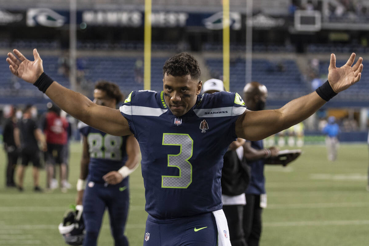 FILE - Seattle Seahawks quarterback Russell Wilson gestures as he walks off the field after an ...